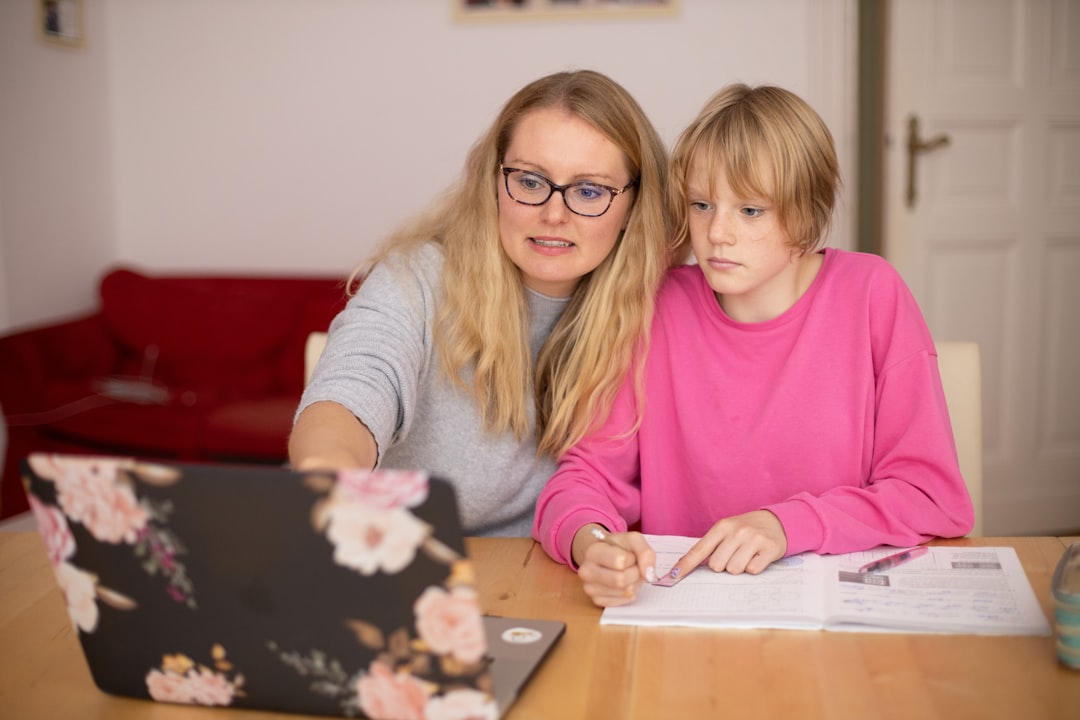 Madre ayudando a su hija a repasar tareas escolares en casa